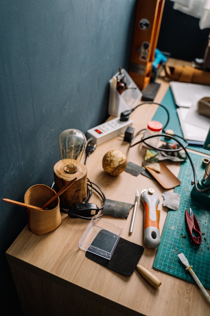 A cluttered workbench showcasing various tools and supplies for creative projects.